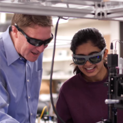 Scott Diddams and graduate students manipulating an optical frequency comb in the Engineering Center lab at CU Boulder