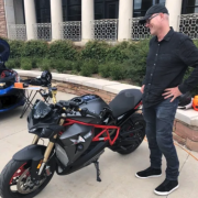 Man stands next to an electric motorcycle