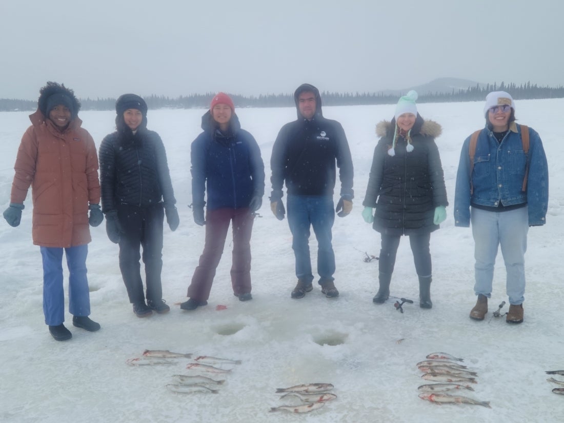 Peyton Thomas stands on a frozen Alaskan lake with five other people