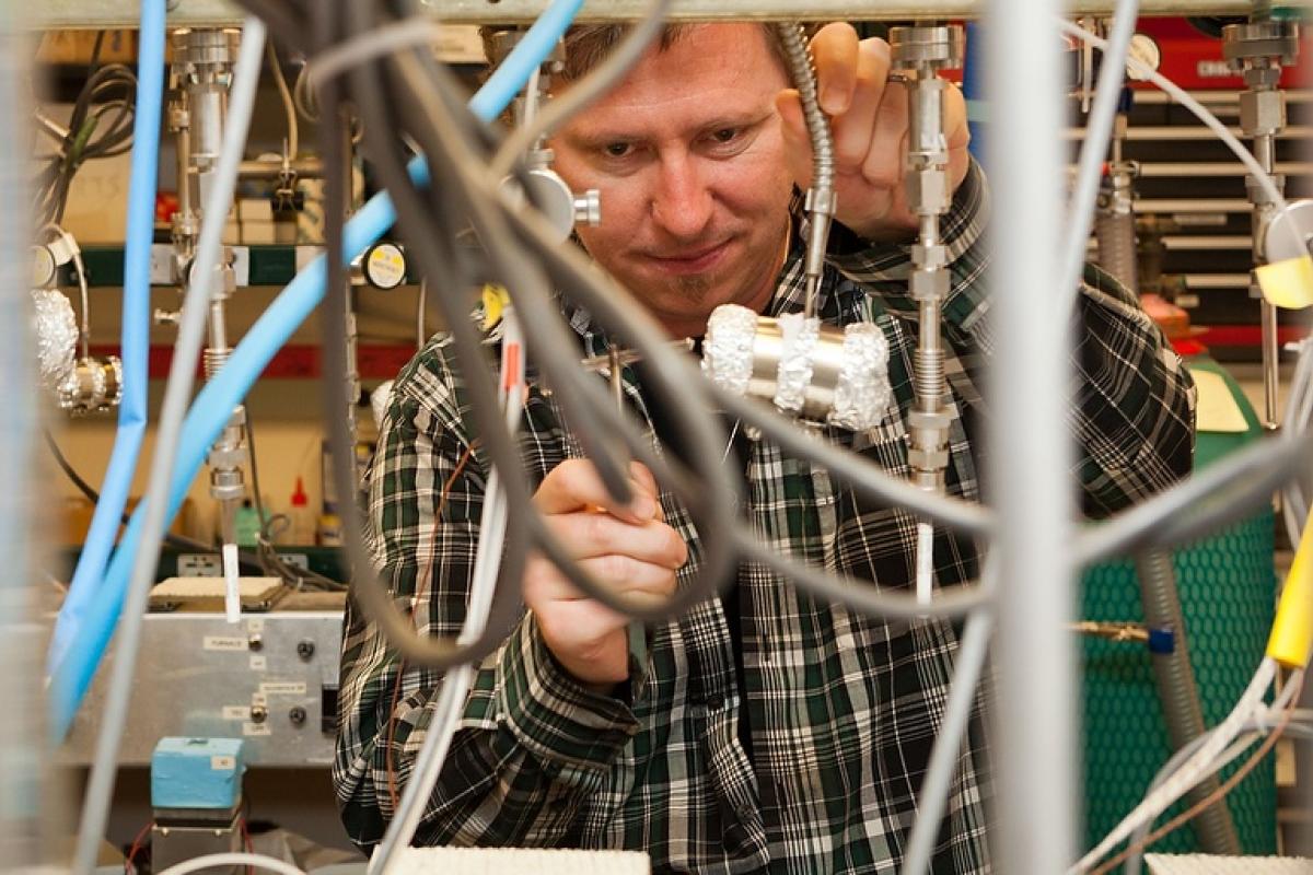 Lab technician works on complex arrangement of tubing and sensors