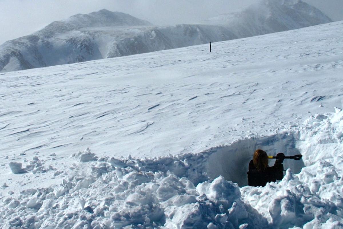 Morgan Zeliff digs a snowpit in the foreground as Jennifer Morse maintains a flux tower in a snow-covered background on Niwot Ridge, Jan 2011. Photo: Danielle Perrot