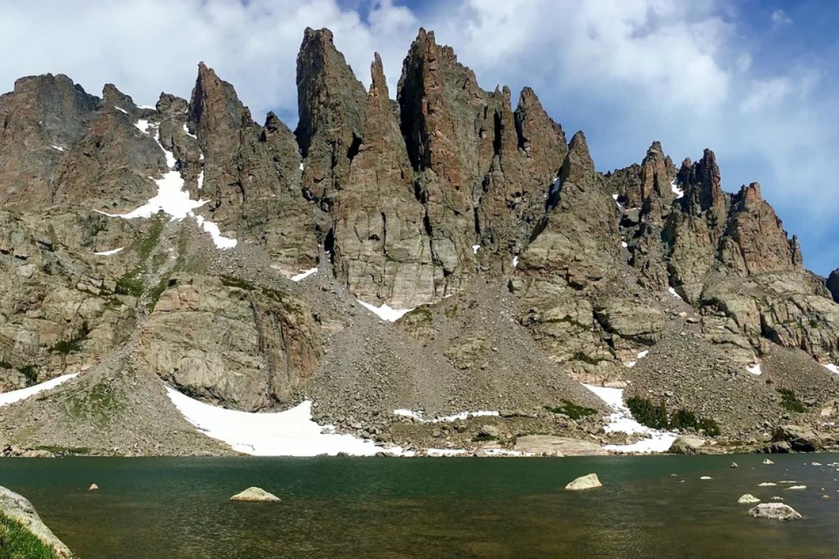 Spiky rock towers loom above Sky Pond in Rocky Mountain National Park