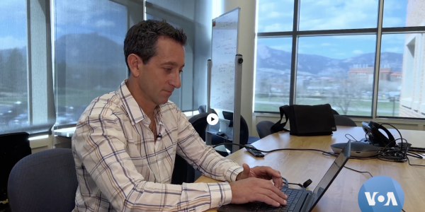 Noah Molotch looks at snowpack data for Colorado on his laptop.