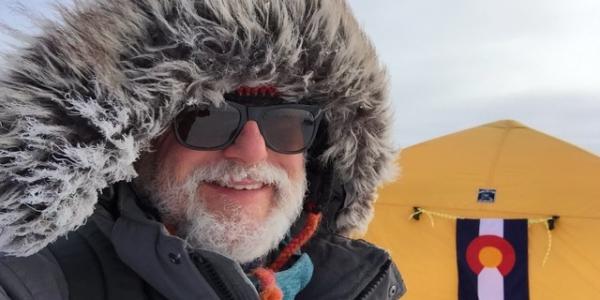 A bearded Bruce Vaughn in a very furry parka and sunglasses