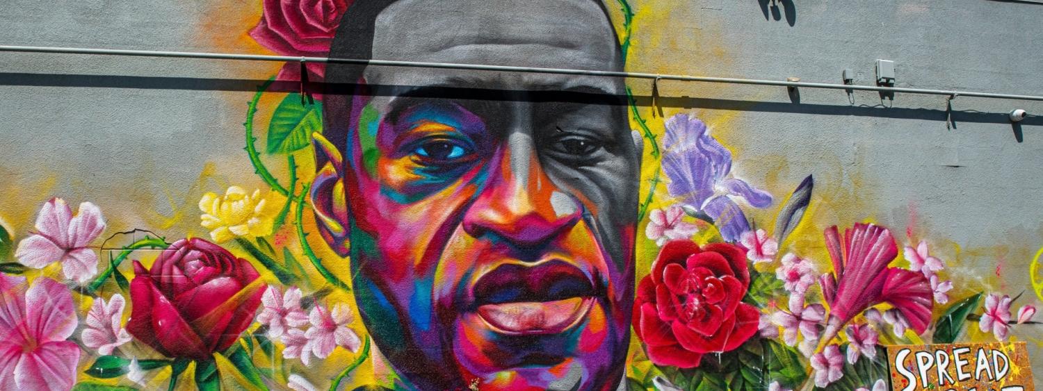 Painted mural of George Floyd surrounded by flowers