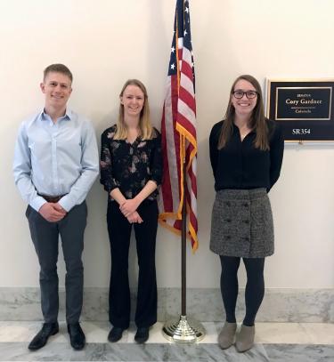 Jonathan Raberg INSTAAR, a senate staff member, and Sarah Crump INSTAAR pose after meeting with Senator Cory Garner's office to talk earth science funding and climate policy 