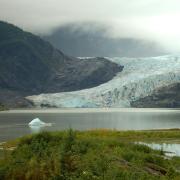 Mendenhall Glacier in Alaska spills over a cliff edge and calves into a lake at its terminus
