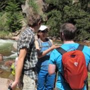 Sarah Spaulding talks with students during a hike to sample diatoms in Rocky Mountain streams.