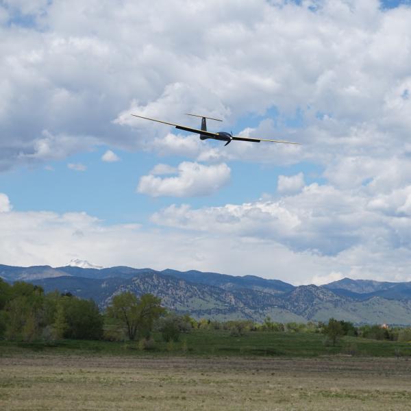 Tempest UAS flying in the foreground with the Colorado Foothills in the background