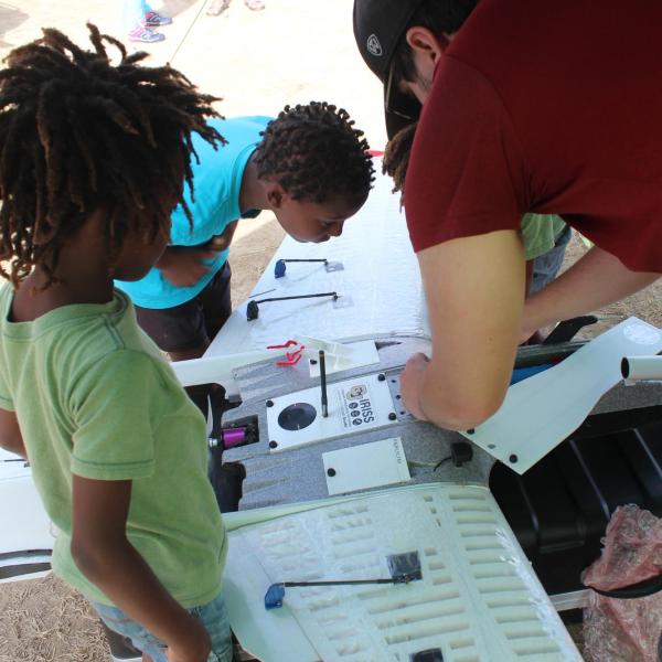 Pilot in Command Chris Choate showing Barbados children the RAAVEN UAS