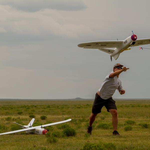 IRISS students Danny L. (left) and Ty G. (right) launching one of three Talons used to test the MUASO (Multi-UAS Ops) ground station