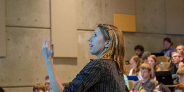 teacher in front of a large full lecture hall