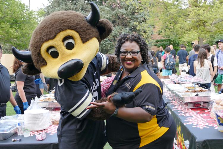 CU Boulder Staff Member Smiling with Chip the Mascot