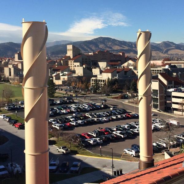 I took this pic from the roof of the East District Energy Plant (on a tour) looking towards the Engineering Center @cuboulder. Notice the helical ridge (#strake) on the chimney to reduce structural #vibration due to the wind flow around it. #vortexshedding #resonance #gallopinggertie #takeatour