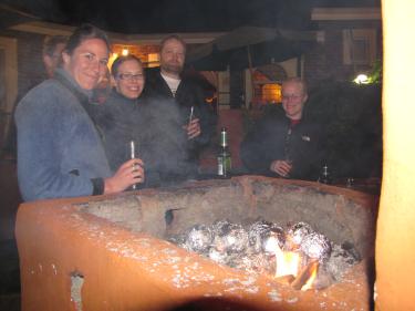 People standing around a braai pit at Kenjara