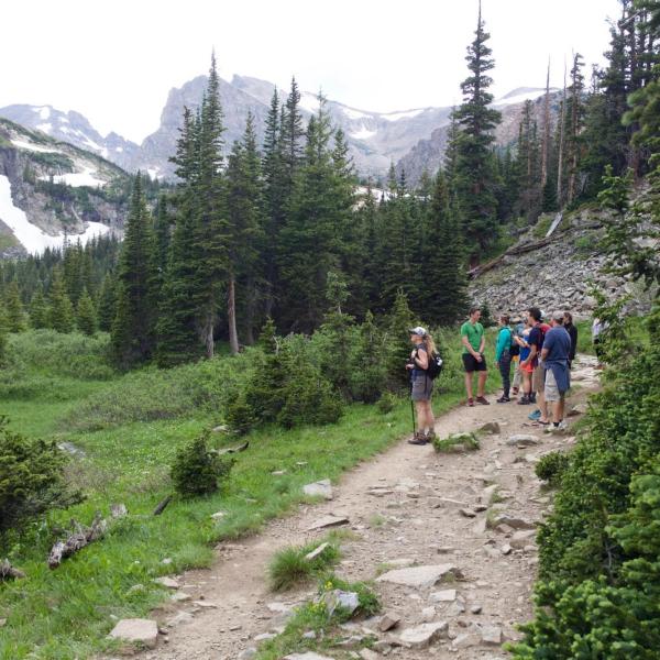 Lab members hiking on the trail with the indian peaks in the background