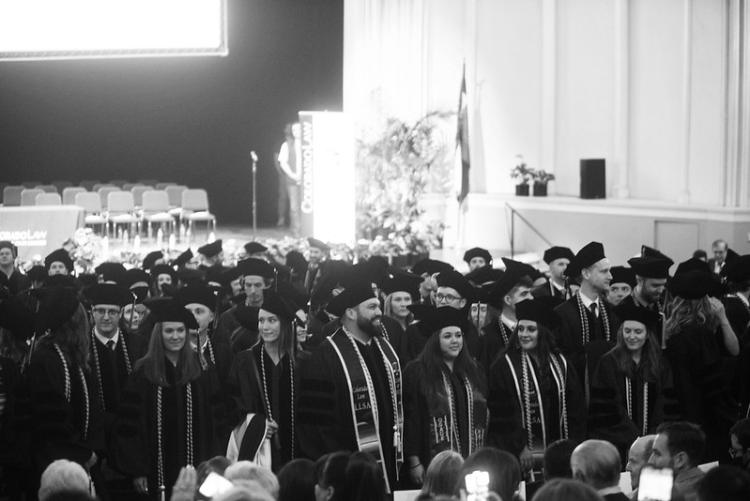 Black and white photo of graduates in Macky Auditorium