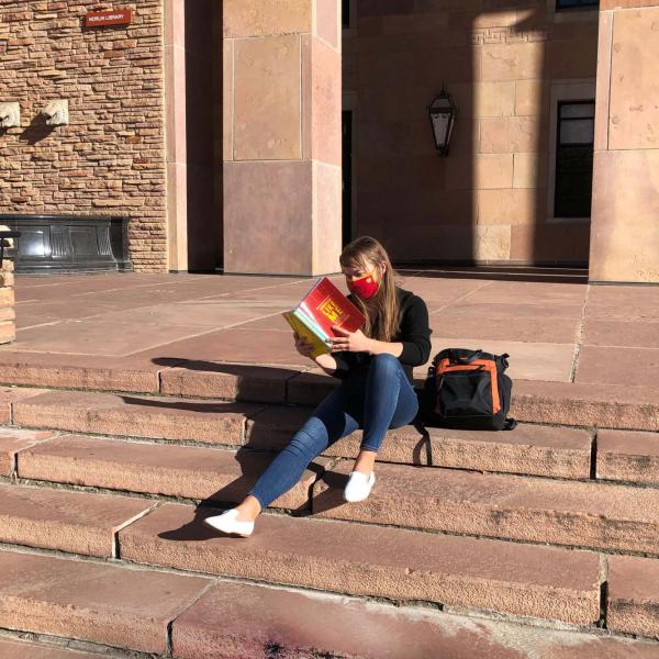 person reading on the steps of Norlin Library