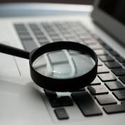 A magnifying glass over a keyboard.