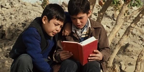 Photo of two boys reading a book