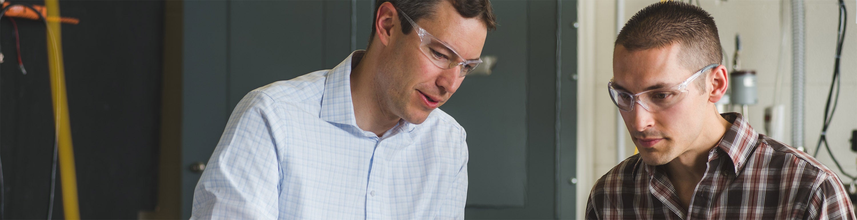 Professor Greg Reiker talking with a graduate student.