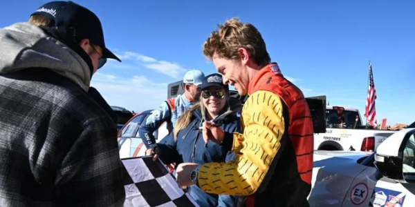Nichols signs an autograph at the top of Pikes Peak after completing the race