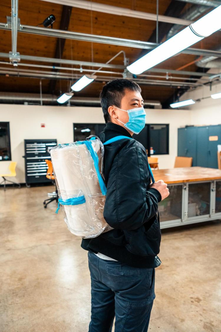 Gary Yu with device in backpack.