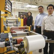 Xiaobo Yin and Ronngui Yang in a lab with the film.