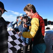 Nichols signs an autograph at the top of Pikes Peak after completing the race