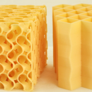 Side-by-side view of two kinds of yellow foam, one with a traditional design and the other with the team's new "honeycomb" design