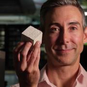 Wil Srubar with a block of his algae-derived concrete.