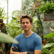 Elliot Strand in a greenhouse.