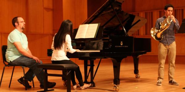 pianist on stage working with a horn player