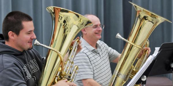 student and faculty member playing tuba
