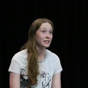 student rehearses on stage
