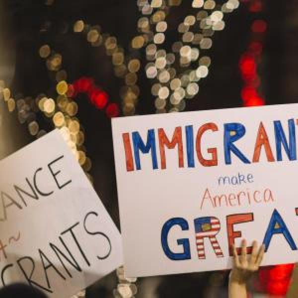 People holding up pro-immigrant signs during a rally