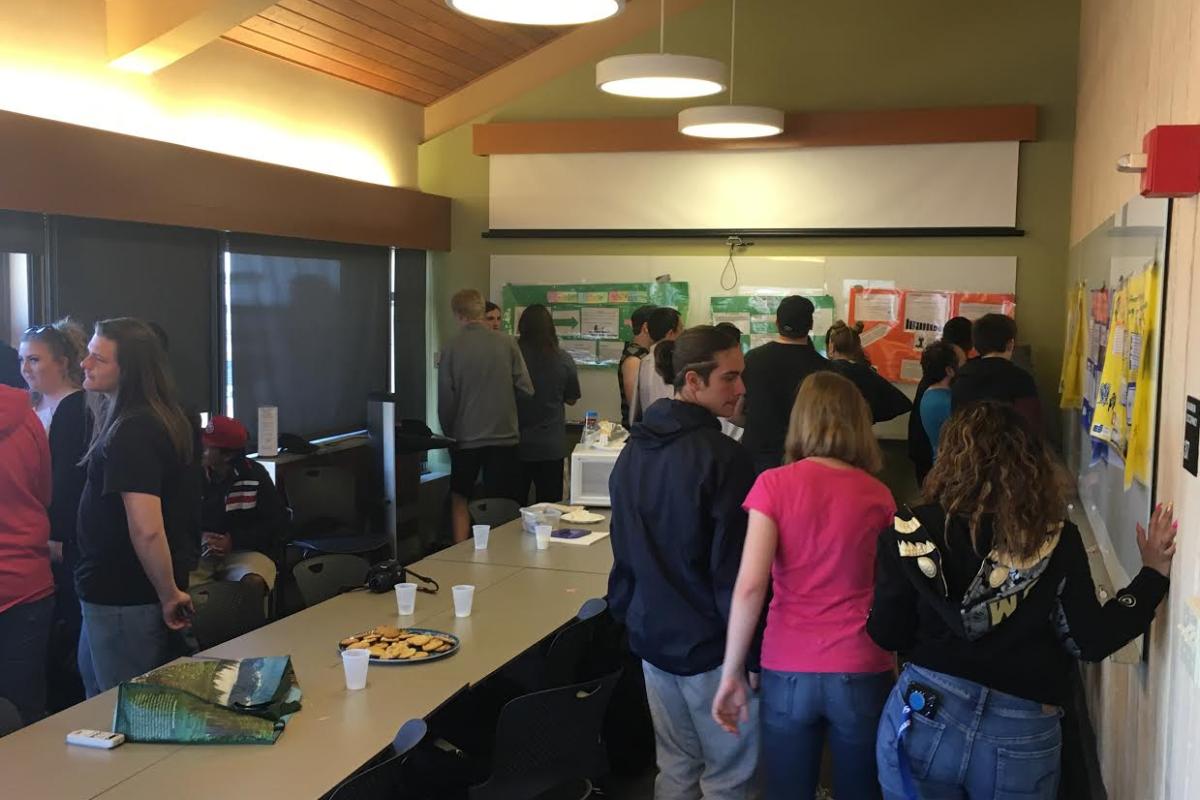 High school PISEC students participating in a poster symposium