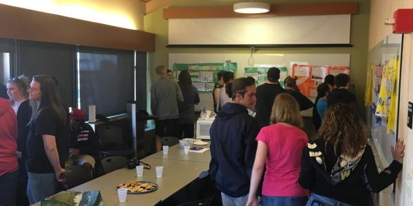 High school PISEC students participating in a poster symposium