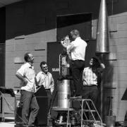 A rocket pointing control unit being checked by four Ball Brothers staff, 1965. Courtesy of Boulder Historical Society.