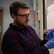NIST and CU Boulder research Sam Oberdick tests nanoparticles in liquid solution