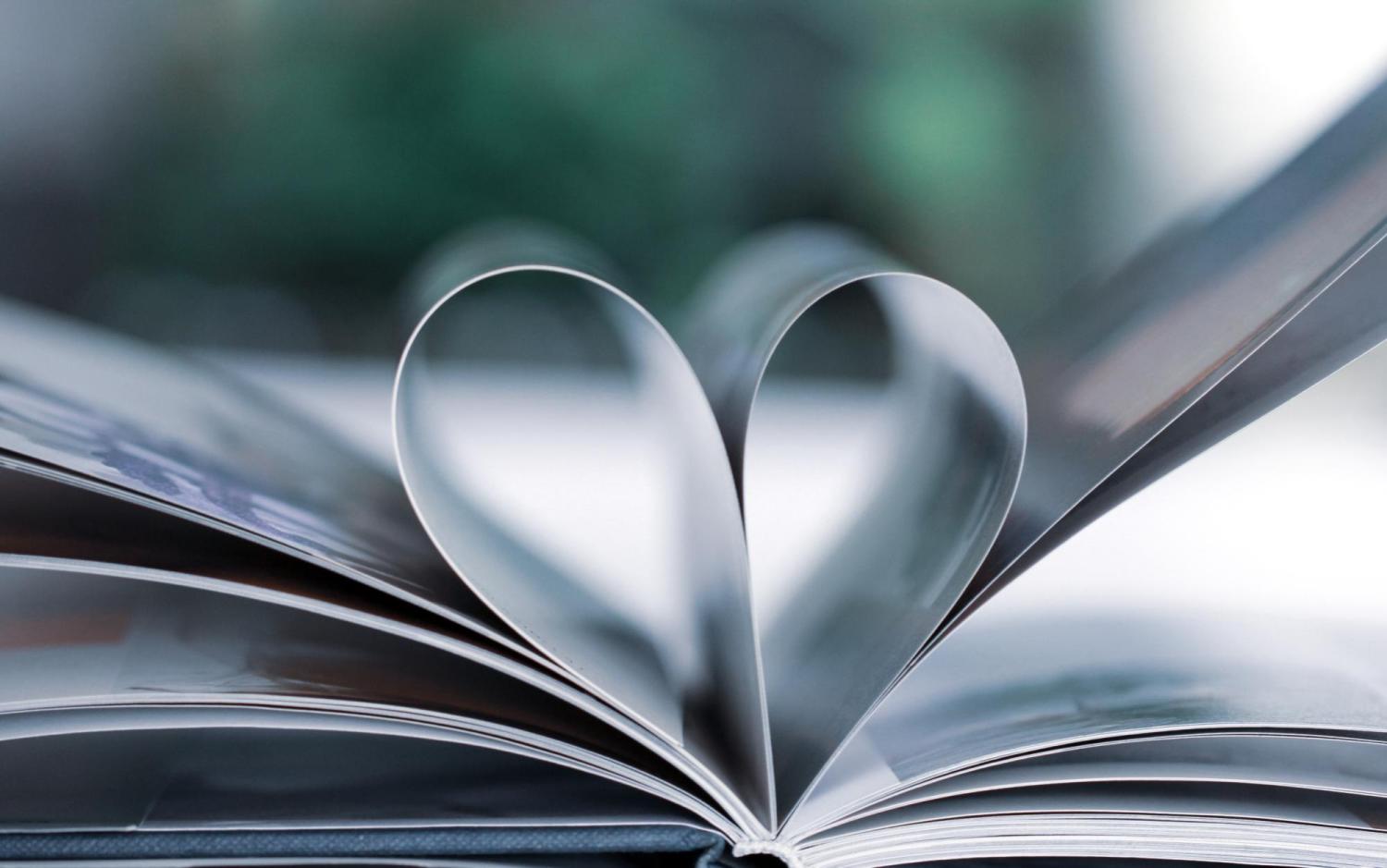 Open book with pages folded to make a heart.