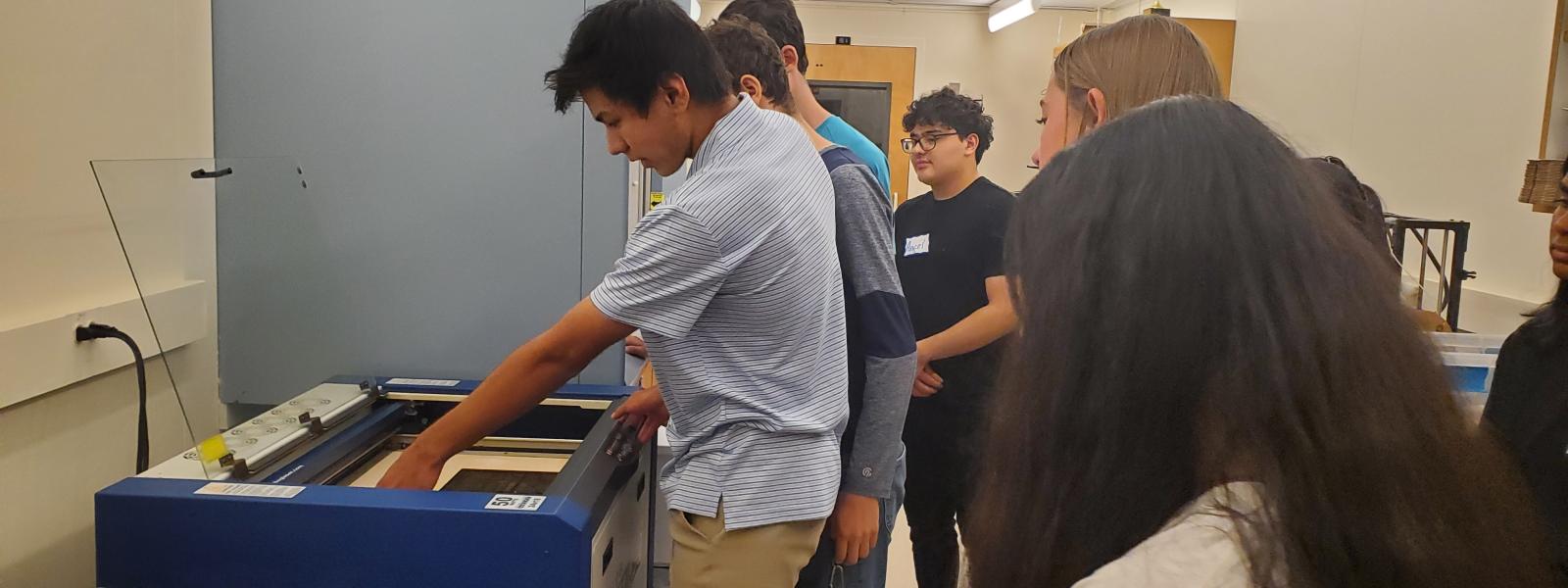 A teen using the Laser printer