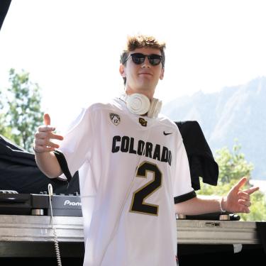 Bruins Standing in Front of DJ Equipment