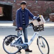 Ravin, CU student and one millionth BCycle rider, poses with his prize package.