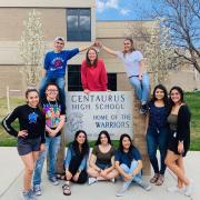 students stand around centaurus high school sign