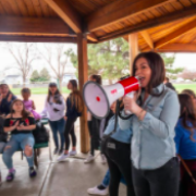 Charla holding megaphone with group of students