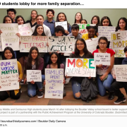 students gather holding signs to support immigration rights 