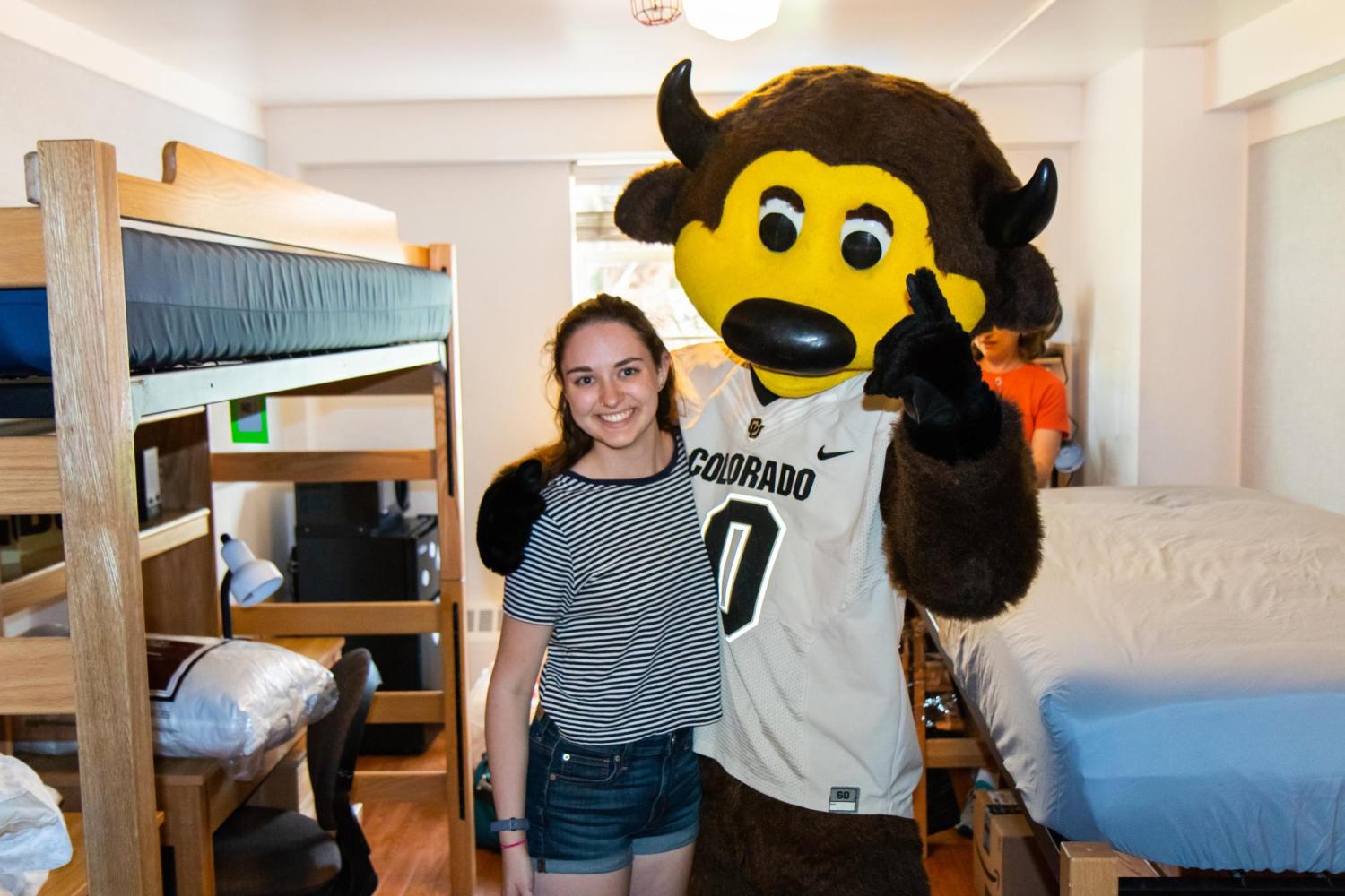 chip and a student posing in the dorms