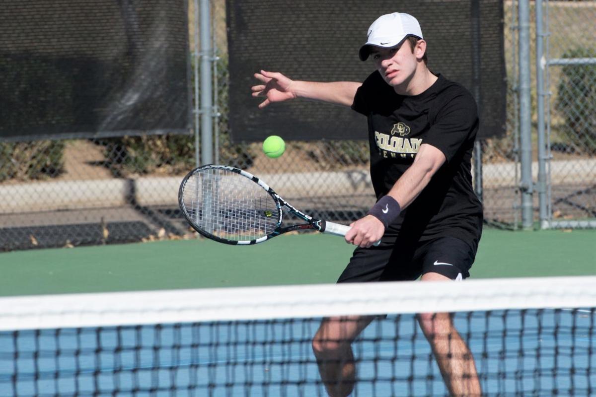 Tennis player serving ball
