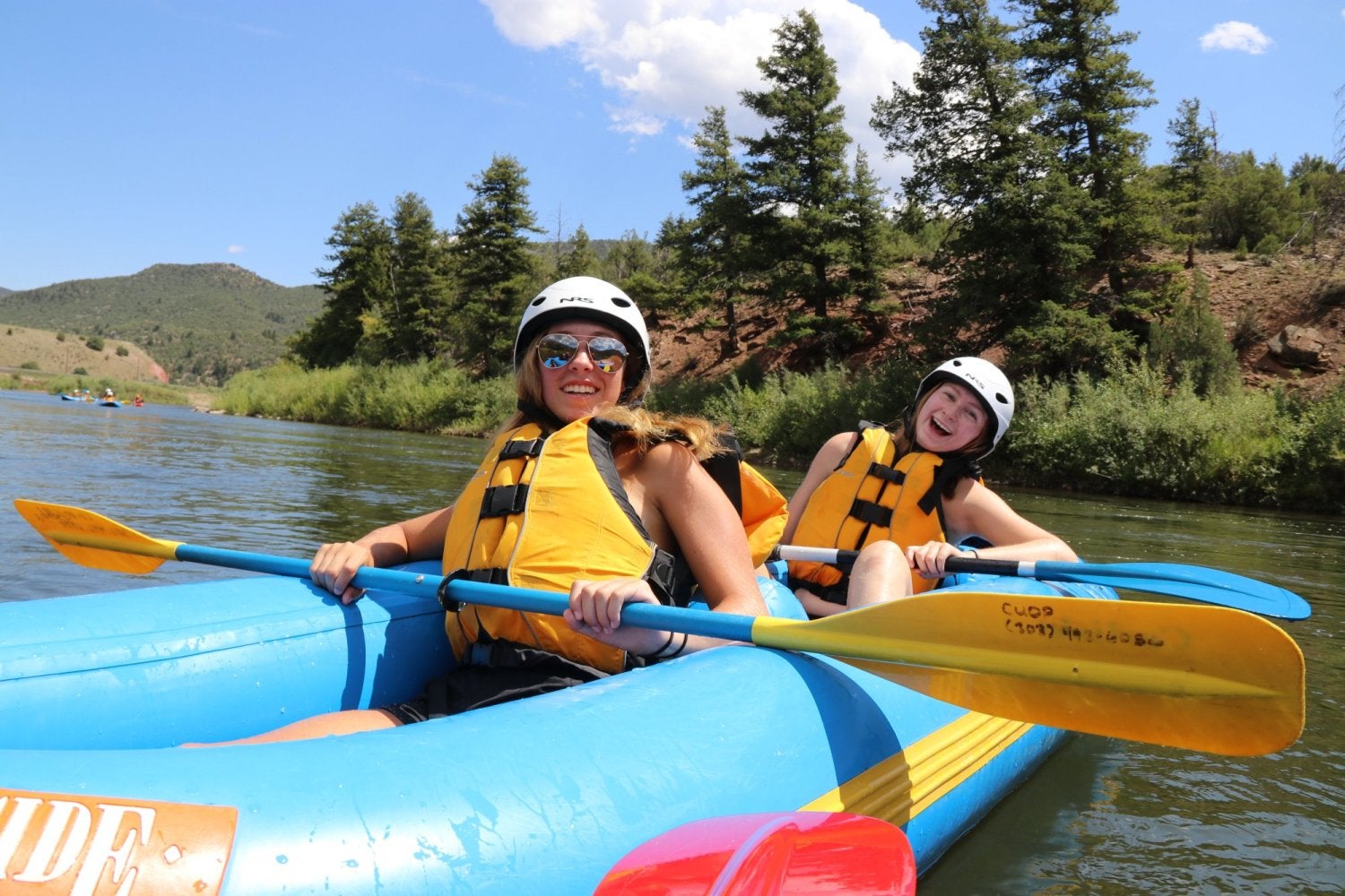two students in a kayak having fun